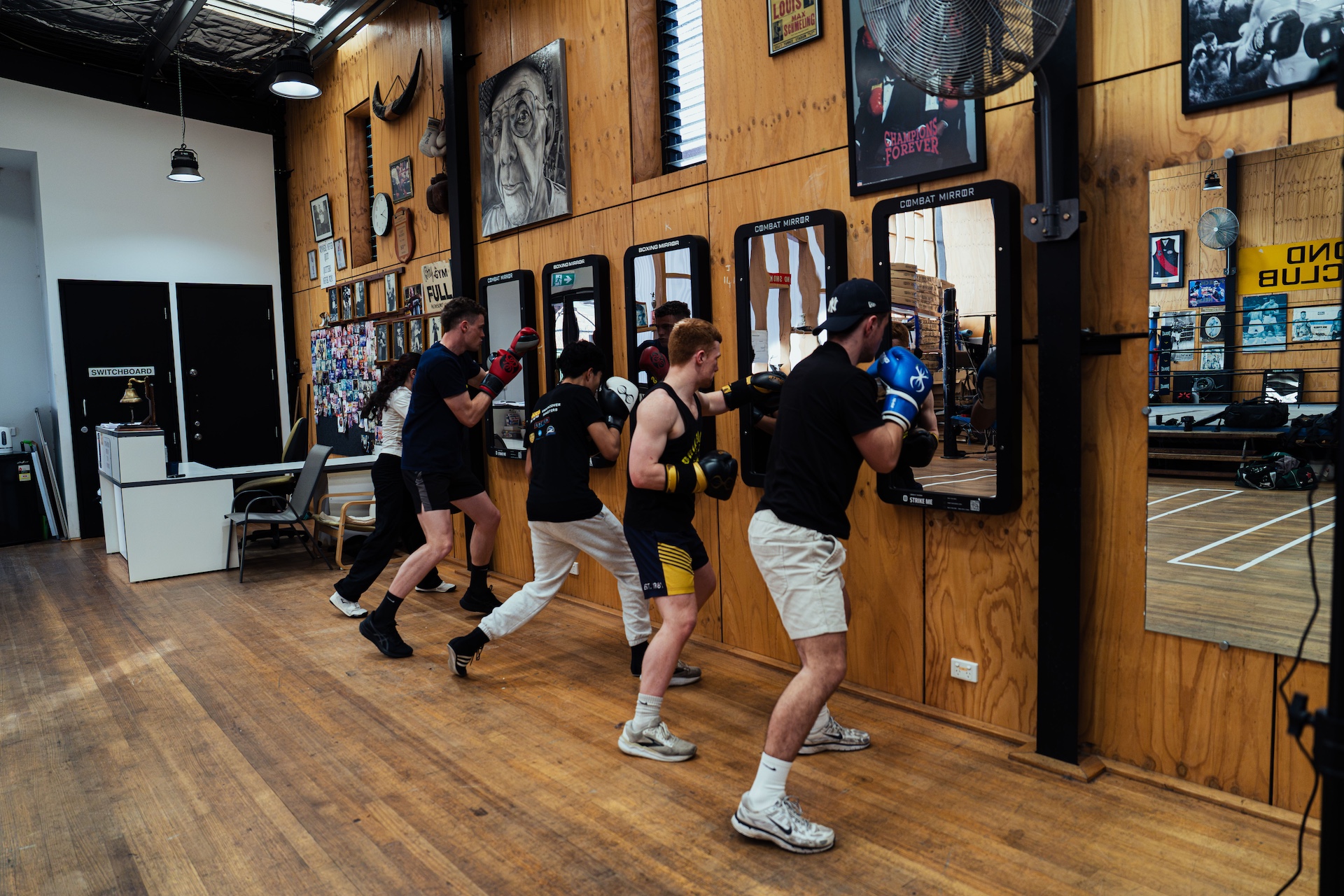 Coach leading a line of boxers through mirror drills