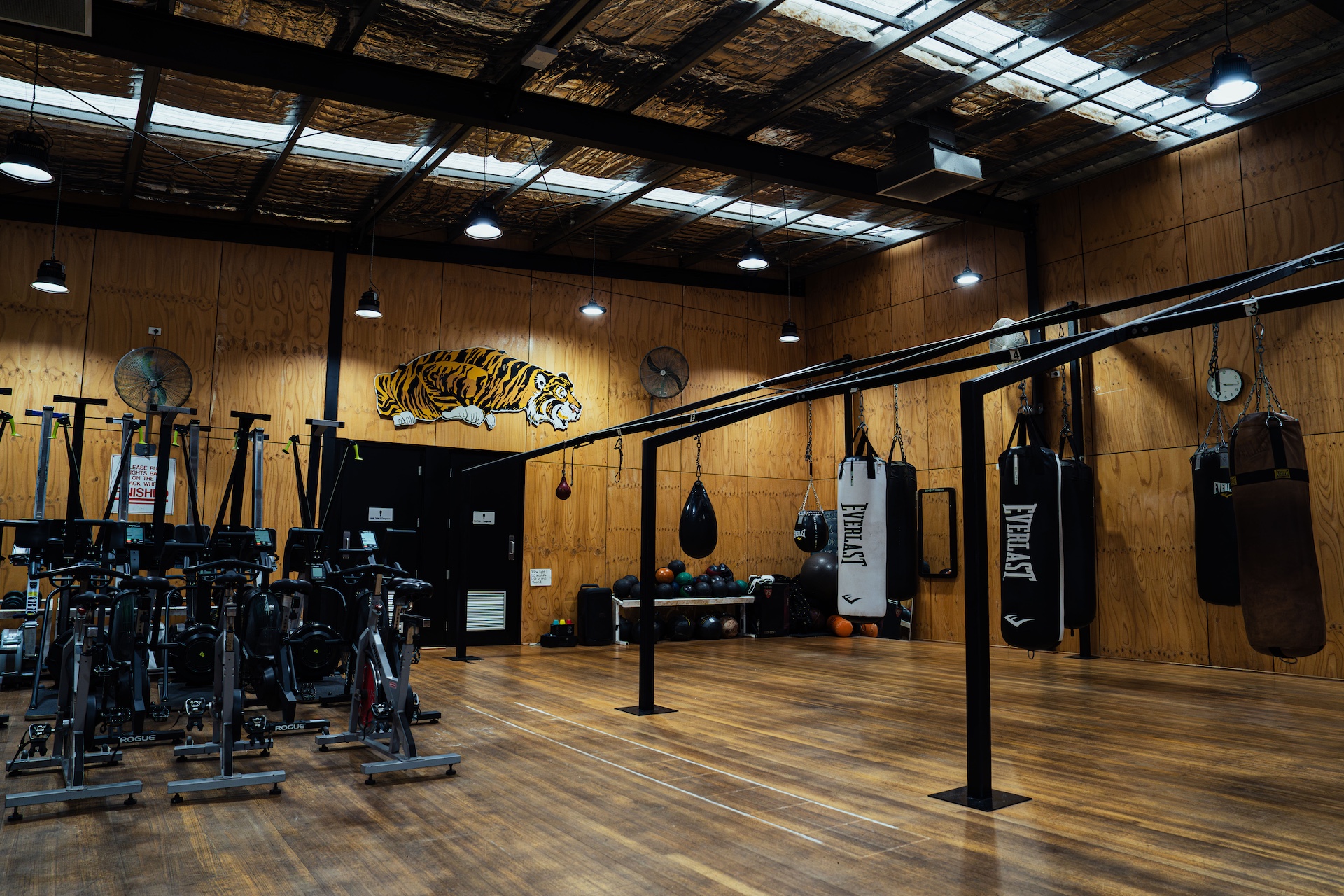 Wide view of the training floor with the Richmond tiger and spin bikes