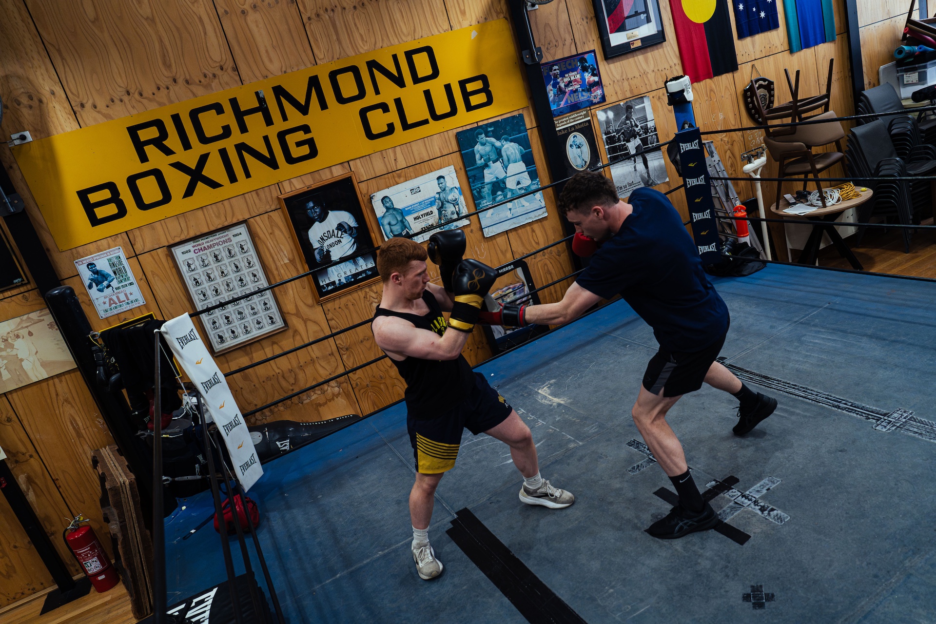 Sparring in the ring seen from above under the club sign